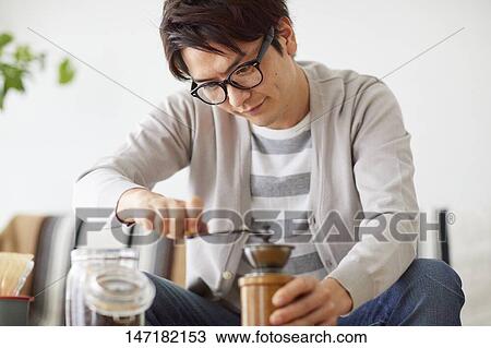 Japanese man making coffee at home View Large Photo Image Stock Image - Japanese man making coffee at home. Fotosearch
