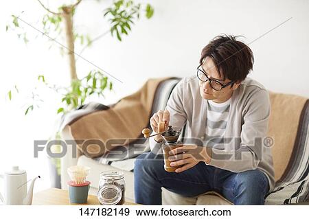Japanese man making coffee at home View Large Photo Image Stock Photo - Japanese man making coffee at home. Fotosearch