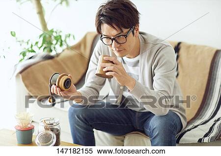 Japanese man making coffee at home View Large Photo Image Stock Photography - Japanese man making coffee at home. Fotosearch