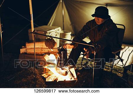 Stock Photo - Japanese man solo camping. Fotosearch