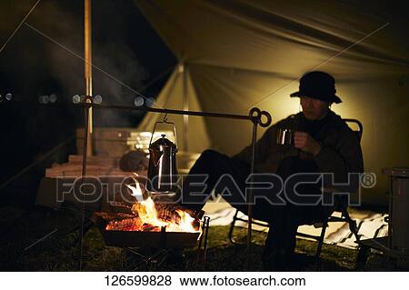 Stock Photo - Japanese man solo camping. Fotosearch