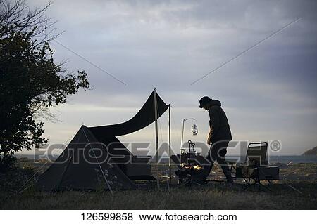 Stock Photo - Japanese man solo camping. Fotosearch