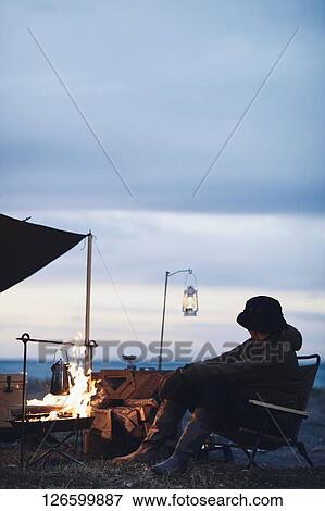 Stock Photo - Japanese man solo camping. Fotosearch