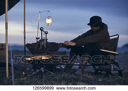 Stock Photo - Japanese man solo camping. Fotosearch