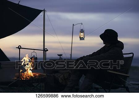 Stock Photograph - Japanese man solo camping. Fotosearch