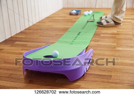 Japanese man training for golf at home View Large Photo Image Stock Image - Japanese man training for golf at home. Fotosearch