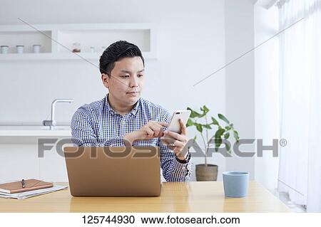 Japanese man working from home View Large Photo Image Stock Image - Japanese man working from home. Fotosearch