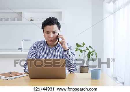 Japanese man working from home View Large Photo Image Stock Image - Japanese man working from home. Fotosearch