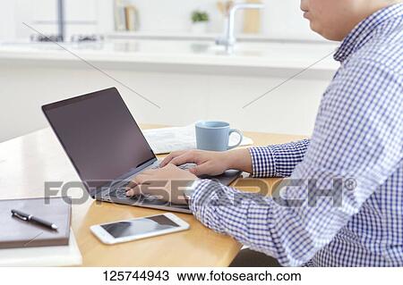 Japanese man working from home View Large Photo Image Stock Image - Japanese man working from home. Fotosearch