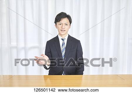 Stock Image - Japanese man working from home. Fotosearch
