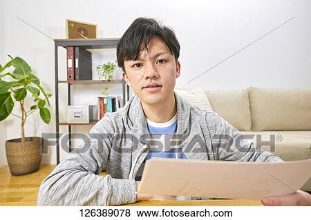 Japanese man working from home View Large Photo Image Stock Photo - Japanese man working from home. Fotosearch