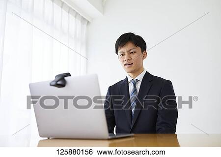 Japanese man working from home View Large Photo Image Stock Photograph - Japanese man working from home. Fotosearch
