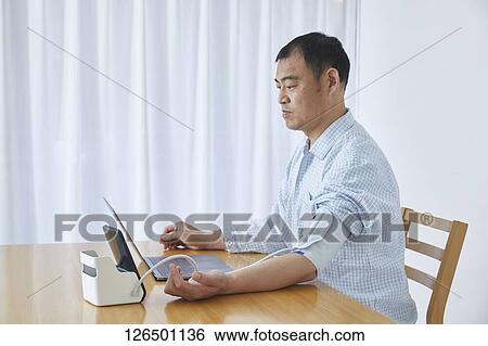 Japanese man working from home View Large Photo Image Stock Photograph - Japanese man working from home. Fotosearch
