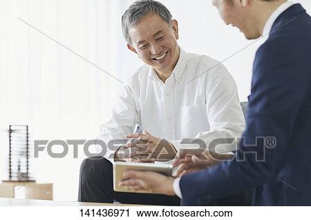 Stock Image - Japanese Middle Aged Man Smiling In The Room. Fotosearch
