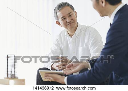 Stock Image - Japanese Middle Aged Man Smiling In The Room. Fotosearch