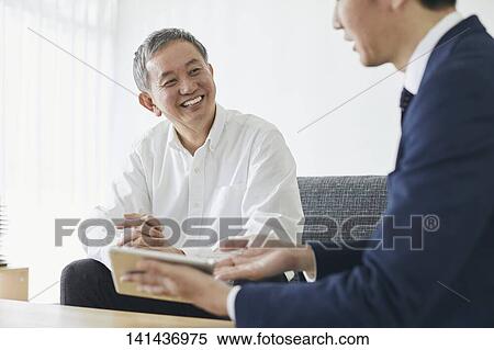 Stock Photography - Japanese Middle Aged Man Smiling In The Room. Fotosearch