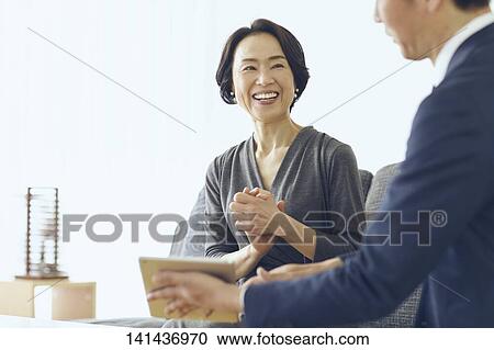 Stock Image - Japanese Middle Aged Woman Smiling In The Room. Fotosearch
