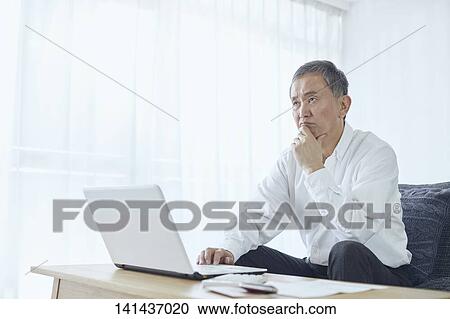 Stock Image - Japanese Senior At Home. Fotosearch