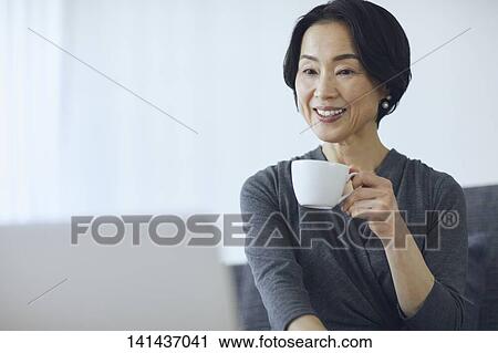 Stock Image - Japanese Senior At Home. Fotosearch