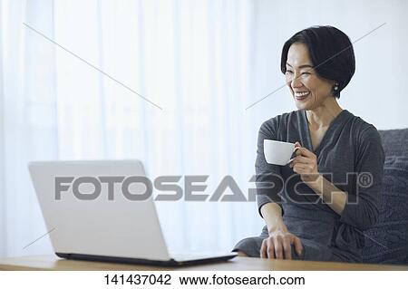 Stock Image - Japanese Senior At Home. Fotosearch