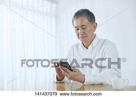 Stock Photo - Japanese Senior At Home. Fotosearch
