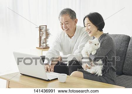 Stock Image - Japanese Senior Couple In The Room. Fotosearch