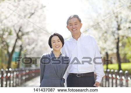 Stock Photo - Japanese Senior Couple Smiling Outside. Fotosearch
