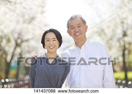 Stock Photo - Japanese Senior Couple Smiling Outside. Fotosearch