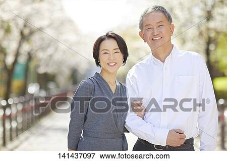 Stock Photo - Japanese Senior Couple Smiling Outside. Fotosearch