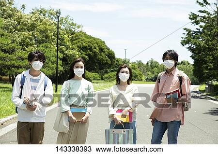 Stock Image - Japanese university students at a city park. Fotosearch