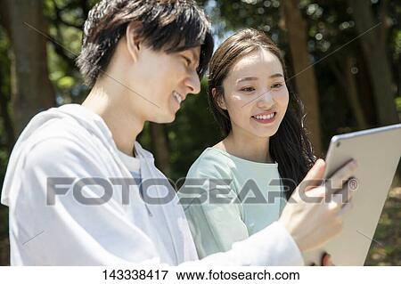 Japanese university students at a city park View Large Photo Image Stock Photo - Japanese university students at a city park. Fotosearch
