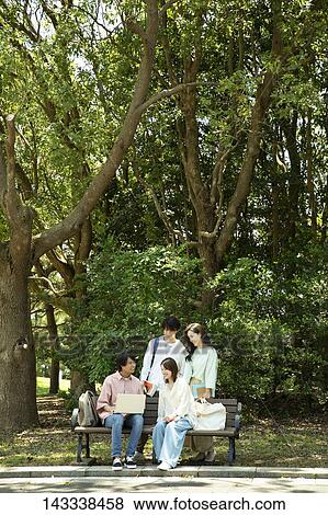 Stock Photo - Japanese university students at a city park. Fotosearch