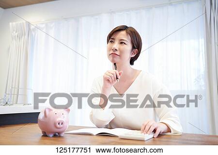 Stock Image - Japanese woman at home. Fotosearch