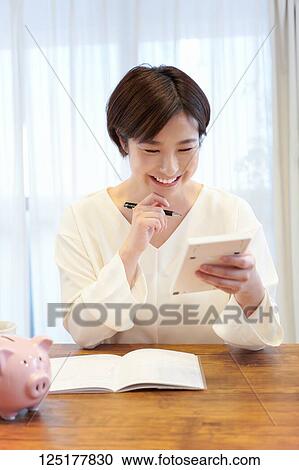 Stock Image - Japanese woman at home. Fotosearch