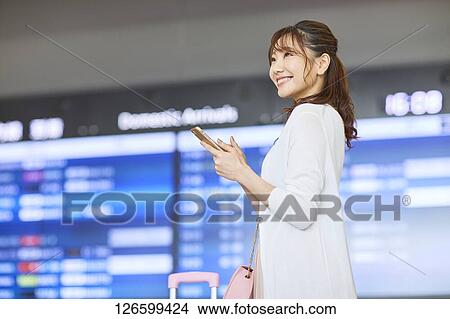 Picture - Japanese woman at the airport. Fotosearch