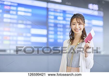 Stock Image - Japanese woman at the airport. Fotosearch