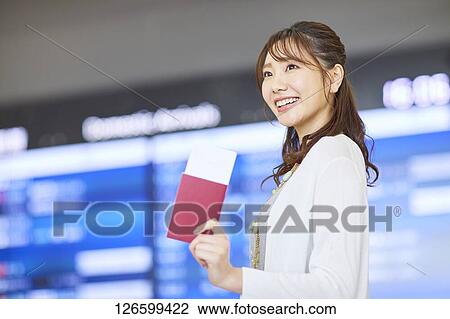 Stock Image - Japanese woman at the airport. Fotosearch