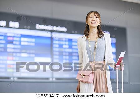 Stock Photo - Japanese woman at the airport. Fotosearch
