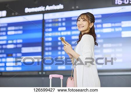 Stock Photo - Japanese woman at the airport. Fotosearch