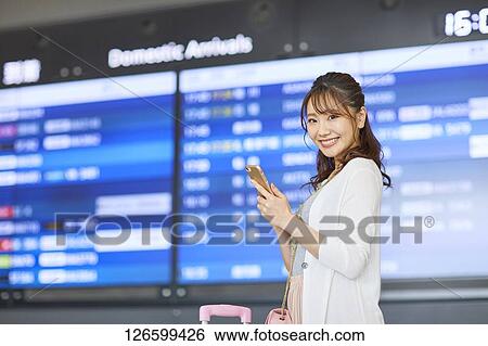 Japanese woman at the airport View Large Photo Image Stock Photograph - Japanese woman at the airport. Fotosearch