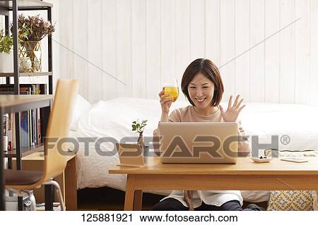 Japanese woman drinking at home remote drinking View Large Photo Image Stock Image - Japanese woman drinking at home remote drinking. Fotosearch