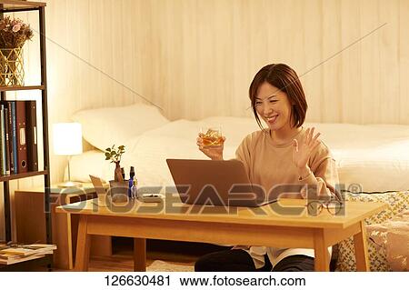 Japanese woman drinking at home remote drinking View Large Photo Image Stock Image - Japanese woman drinking at home remote drinking. Fotosearch