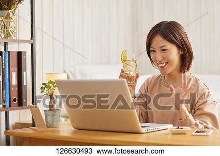 Japanese woman drinking at home remote drinking View Large Photo Image Stock Image - Japanese woman drinking at home remote drinking. Fotosearch