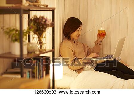 Japanese woman drinking at home remote drinking View Large Photo Image Stock Image - Japanese woman drinking at home remote drinking. Fotosearch