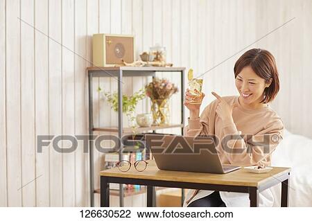 Japanese woman drinking at home remote drinking View Large Photo Image Stock Image - Japanese woman drinking at home remote drinking. Fotosearch