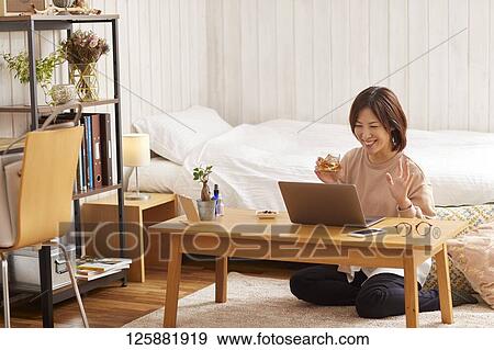 Japanese woman drinking at home remote drinking View Large Photo Image Stock Photo - Japanese woman drinking at home remote drinking. Fotosearch