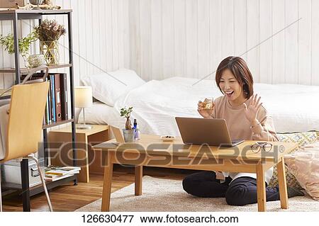 Japanese woman drinking at home remote drinking View Large Photo Image Stock Photo - Japanese woman drinking at home remote drinking. Fotosearch