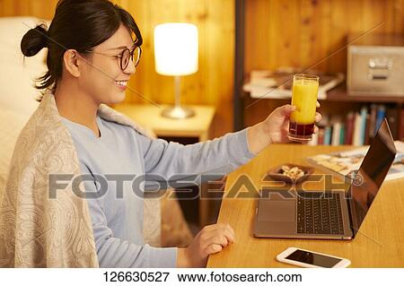 Japanese woman drinking at home remote drinking View Large Photo Image Stock Photo - Japanese woman drinking at home remote drinking. Fotosearch