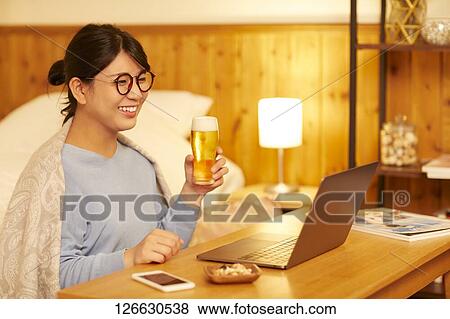 Japanese woman drinking at home remote drinking View Large Photo Image Stock Photo - Japanese woman drinking at home remote drinking. Fotosearch