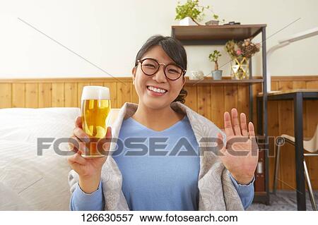 Japanese woman drinking at home remote drinking View Large Photo Image Stock Photo - Japanese woman drinking at home remote drinking. Fotosearch